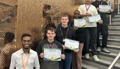 Voktis Operations Director posing with students holding certificates after completing a T Level Digital Support Services project, highlighting IT training and mentorship.